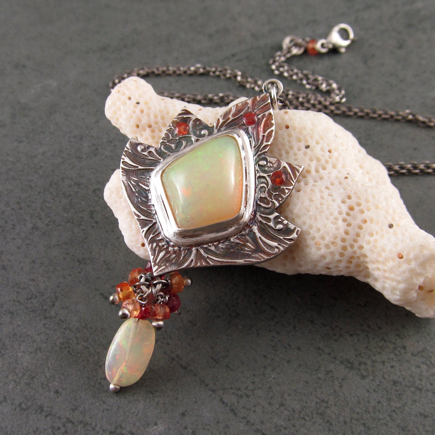 Ethiopian opal pendant with orange and red sapphires