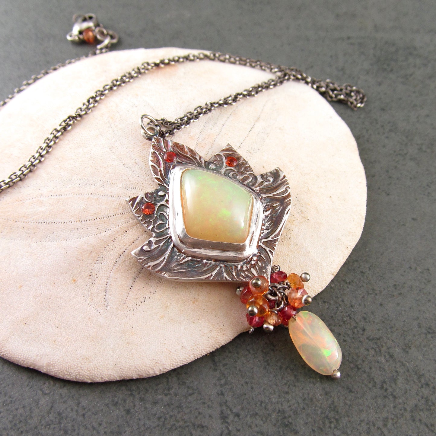 Ethiopian opal pendant with orange and red sapphires