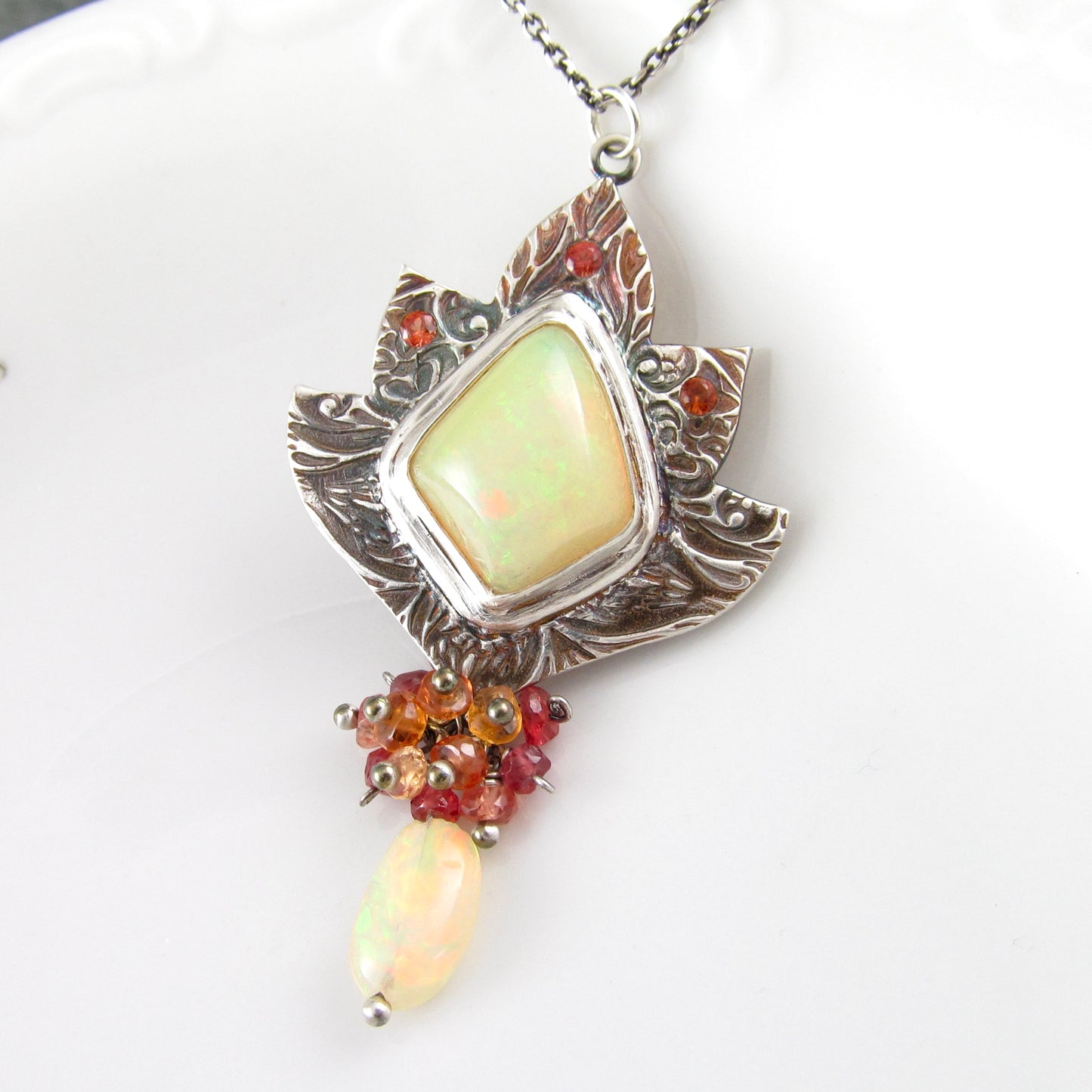 Ethiopian opal pendant with orange and red sapphires