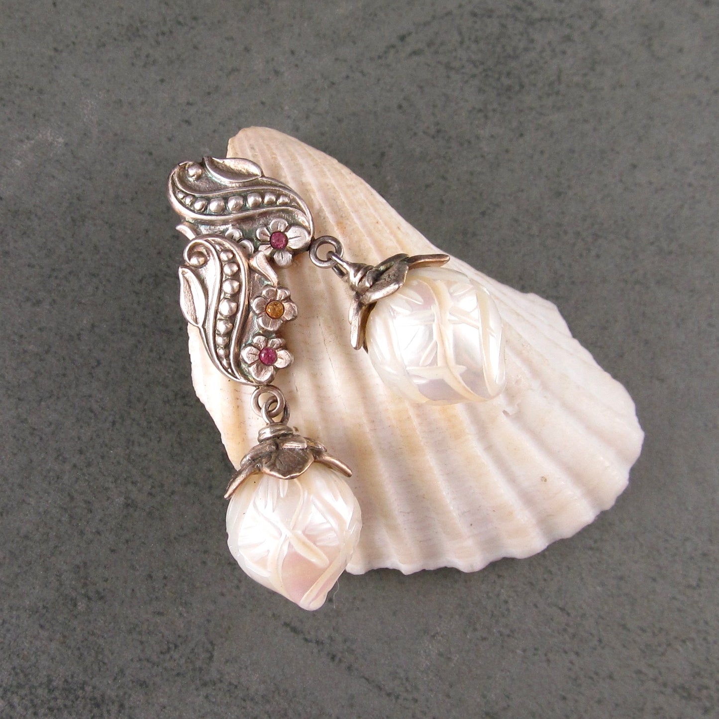 Carved pearl flower bud earrings in fine silver with pastel sapphires