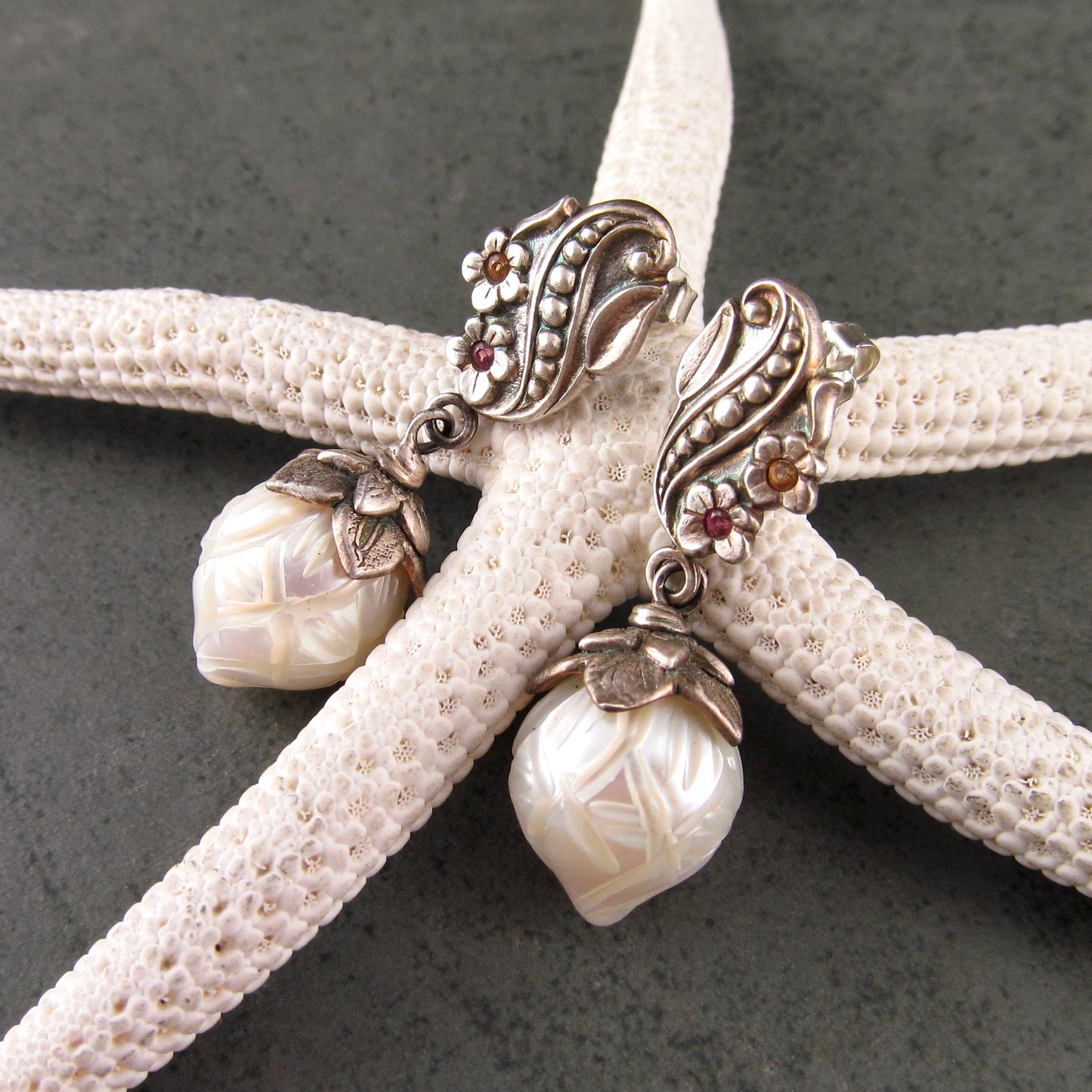 Carved pearl flower bud earrings in fine silver with pastel sapphires