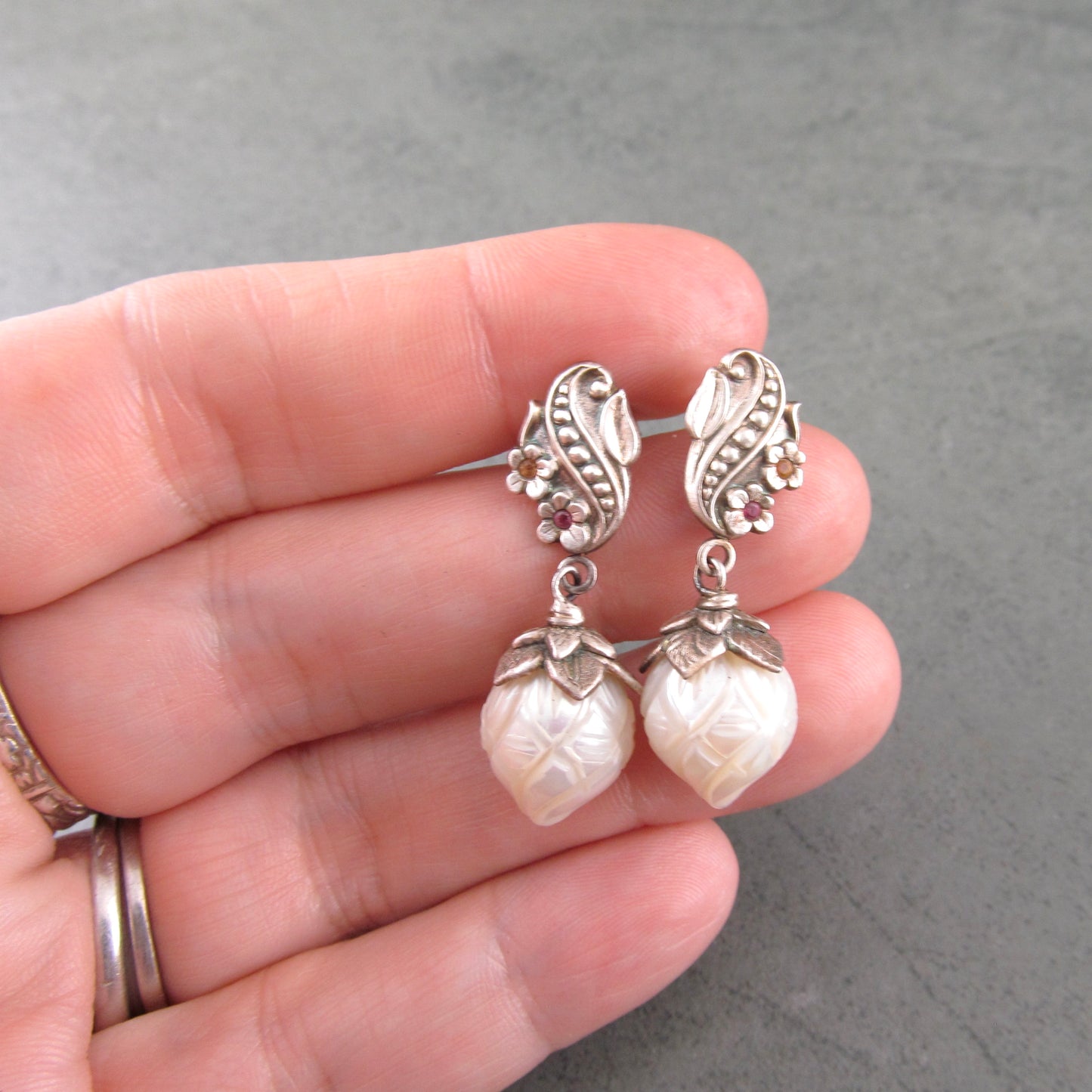 Carved pearl flower bud earrings in fine silver with pastel sapphires